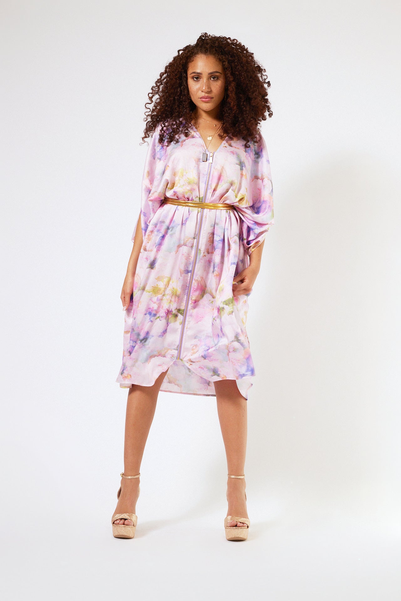 front profile of woman modelling pink floral kaftan duster with front zipper made from recycled textiles
