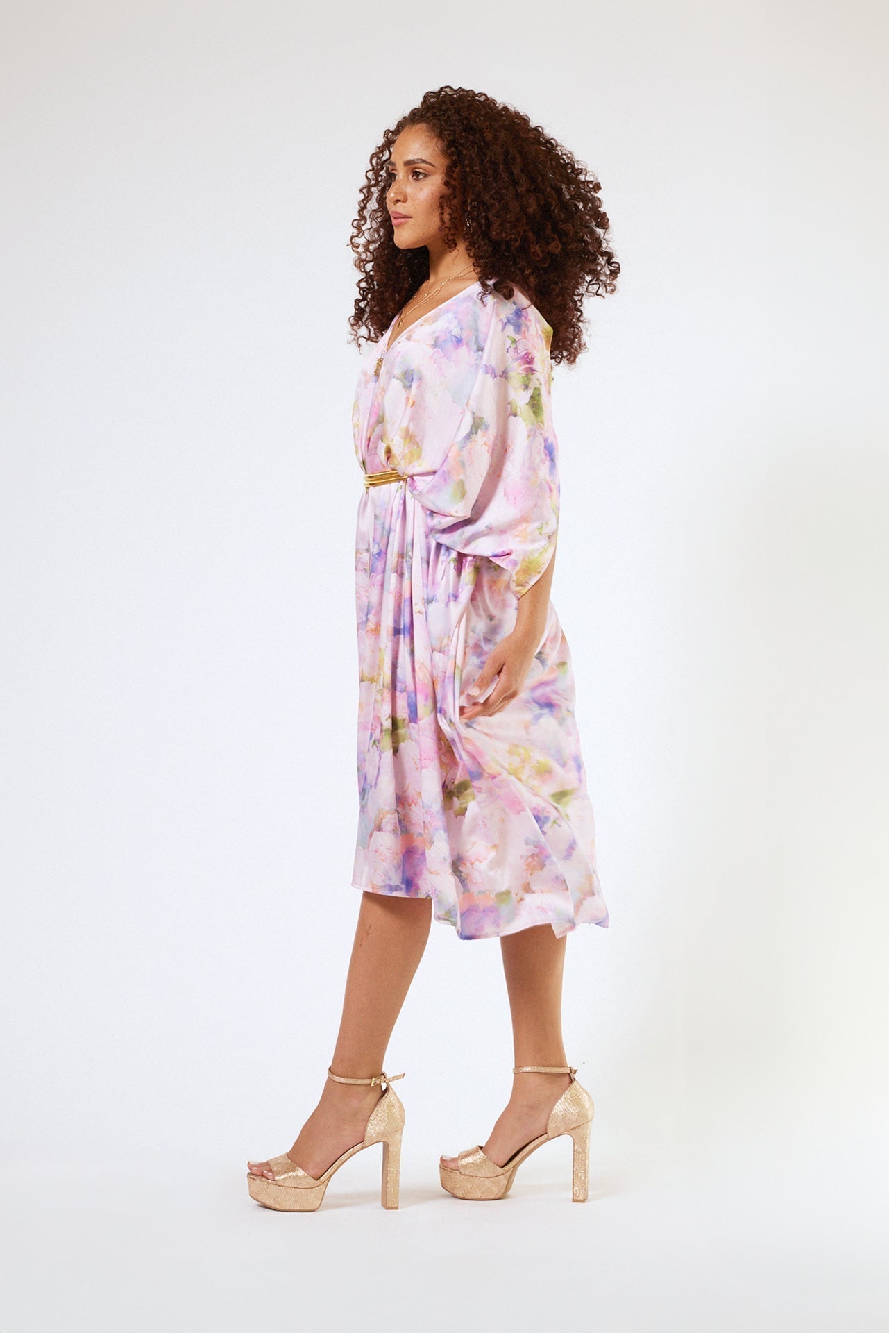 side profile of woman modelling pink floral kaftan duster with front zipper made from recycled textiles 5