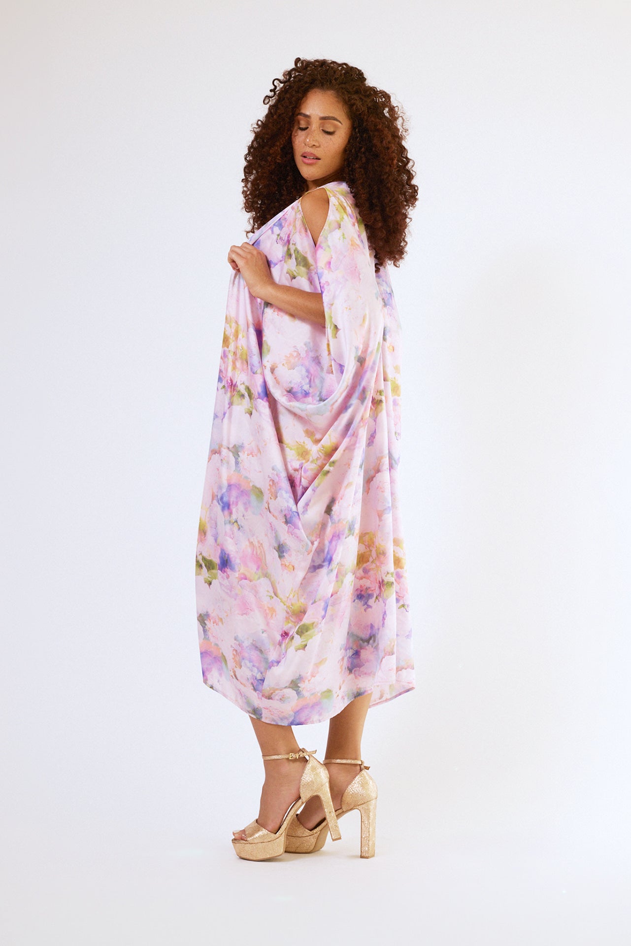 side profile of woman modelling pink floral kaftan duster with front zipper made from recycled textiles