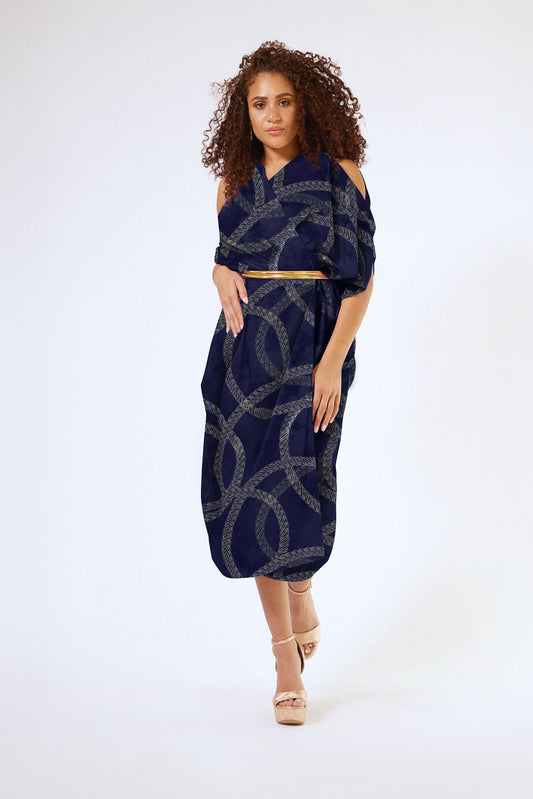 woman modelling gold and black chain printed kaftan duster with front zipper made from recycled materials