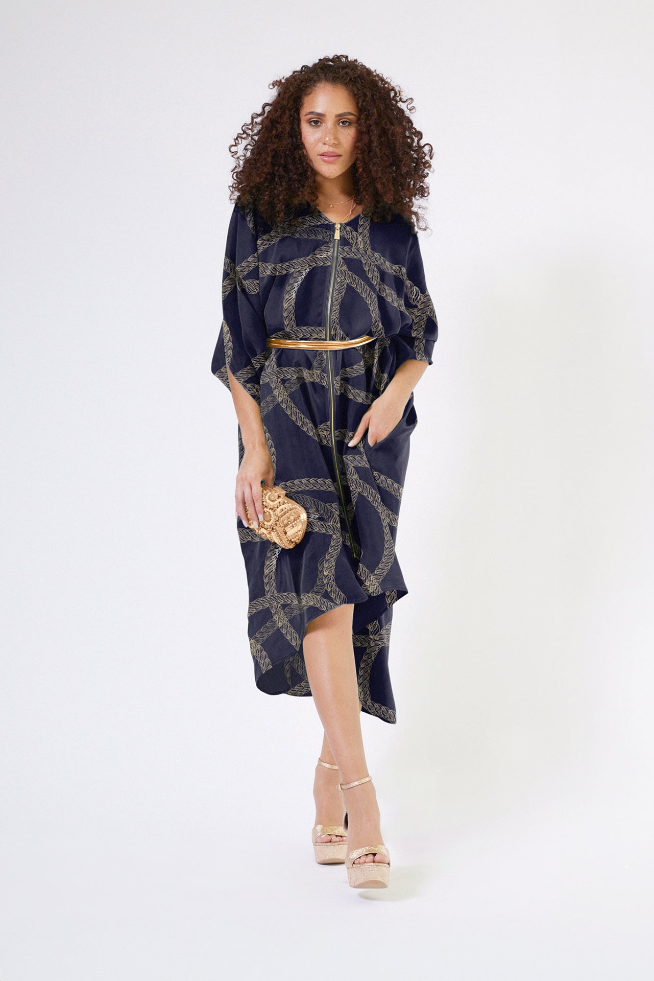 woman modelling gold and black chain printed kaftan duster with front zipper made from recycled materials 4