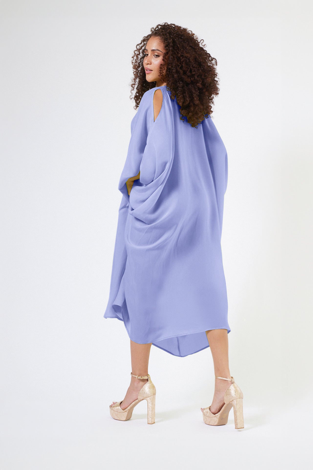 side view of woman modelling a lavender kaftan duster with front zipper made from recycled materials