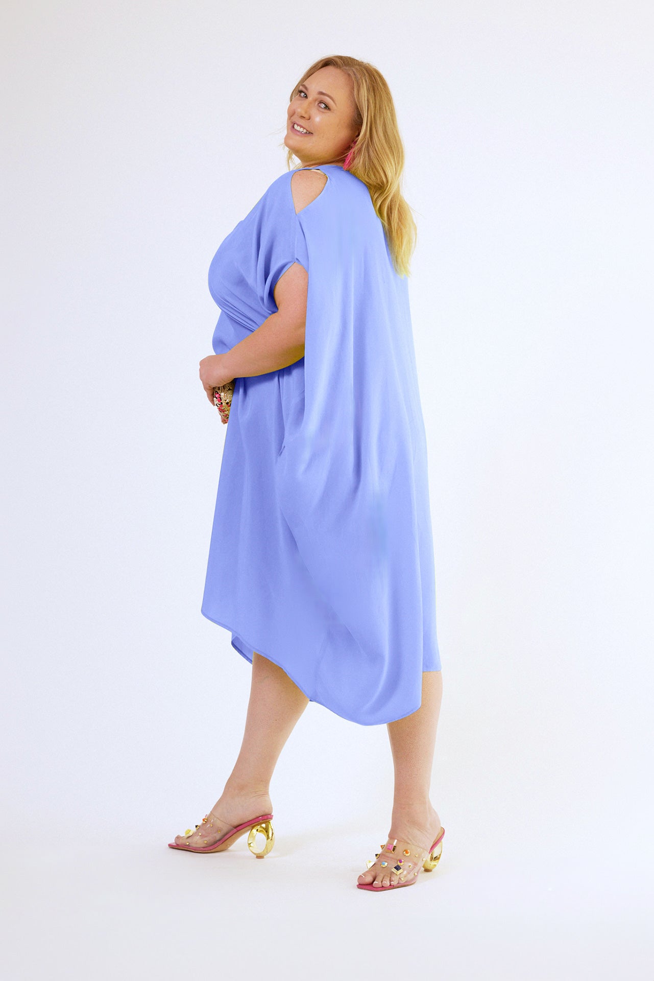 side view of woman modelling a lavender kaftan duster with front zipper made from recycled materials 2