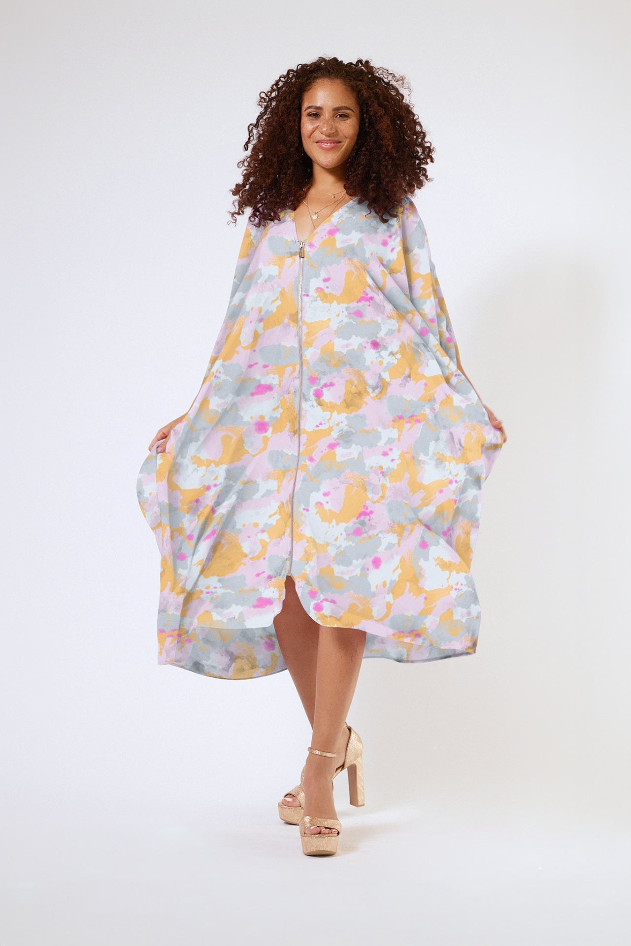 front view of woman modelling a pink army print kaftan duster with front zipper made from recycled materials