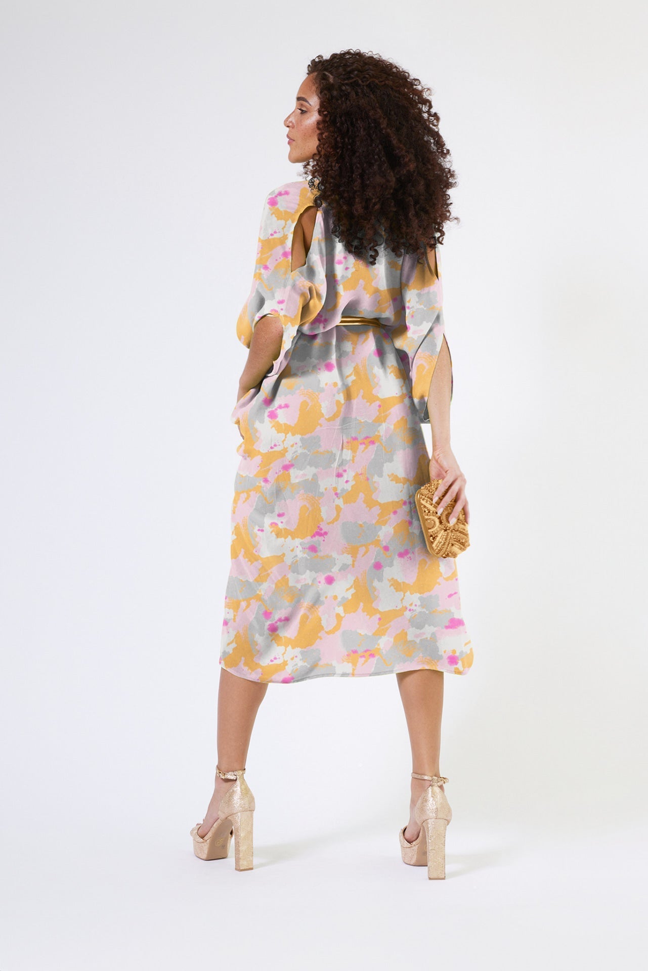 back view of woman modelling a pink army print kaftan duster with front zipper made from recycled materials