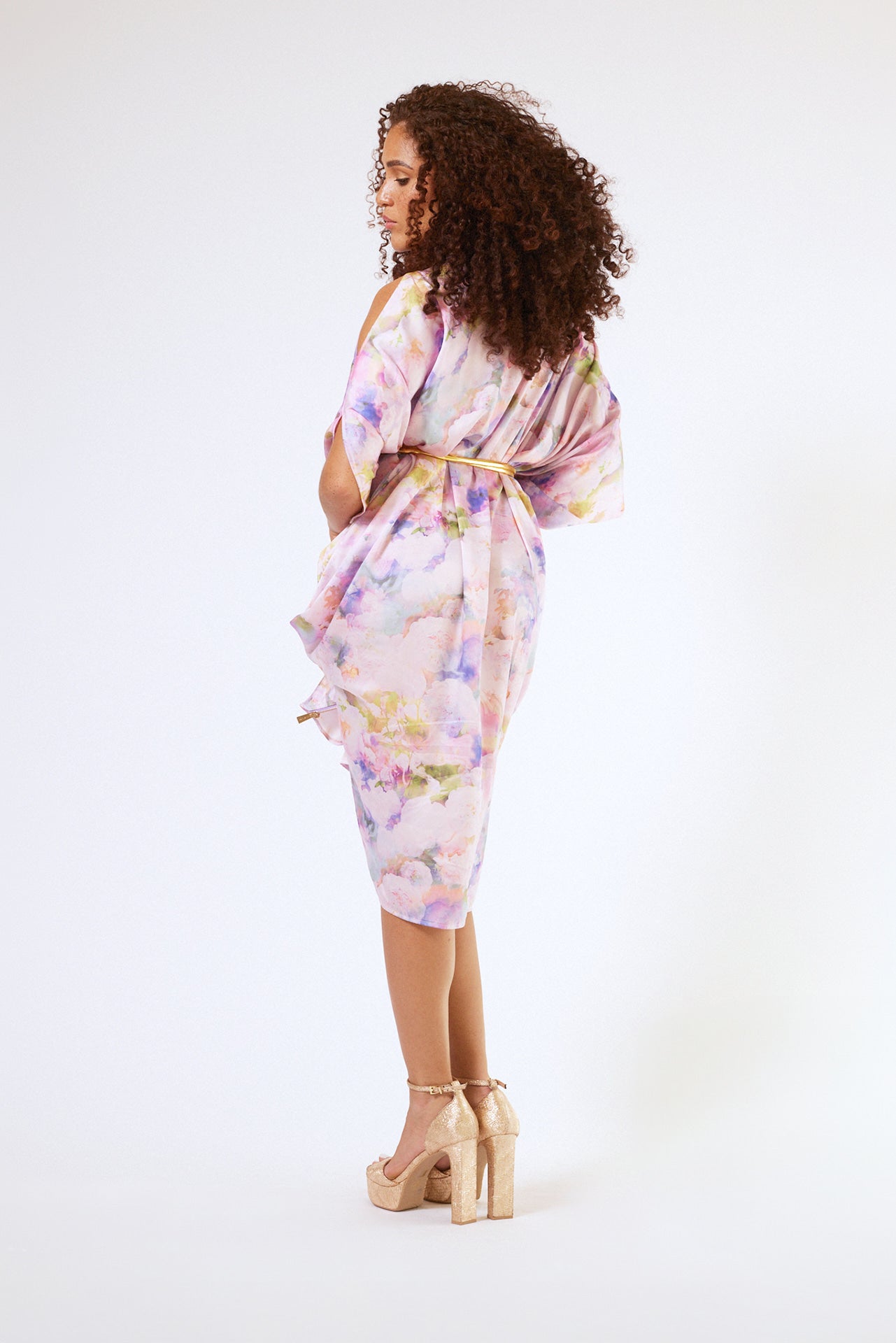 back profile of woman modelling pink floral kaftan duster with front zipper made from recycled textiles 4