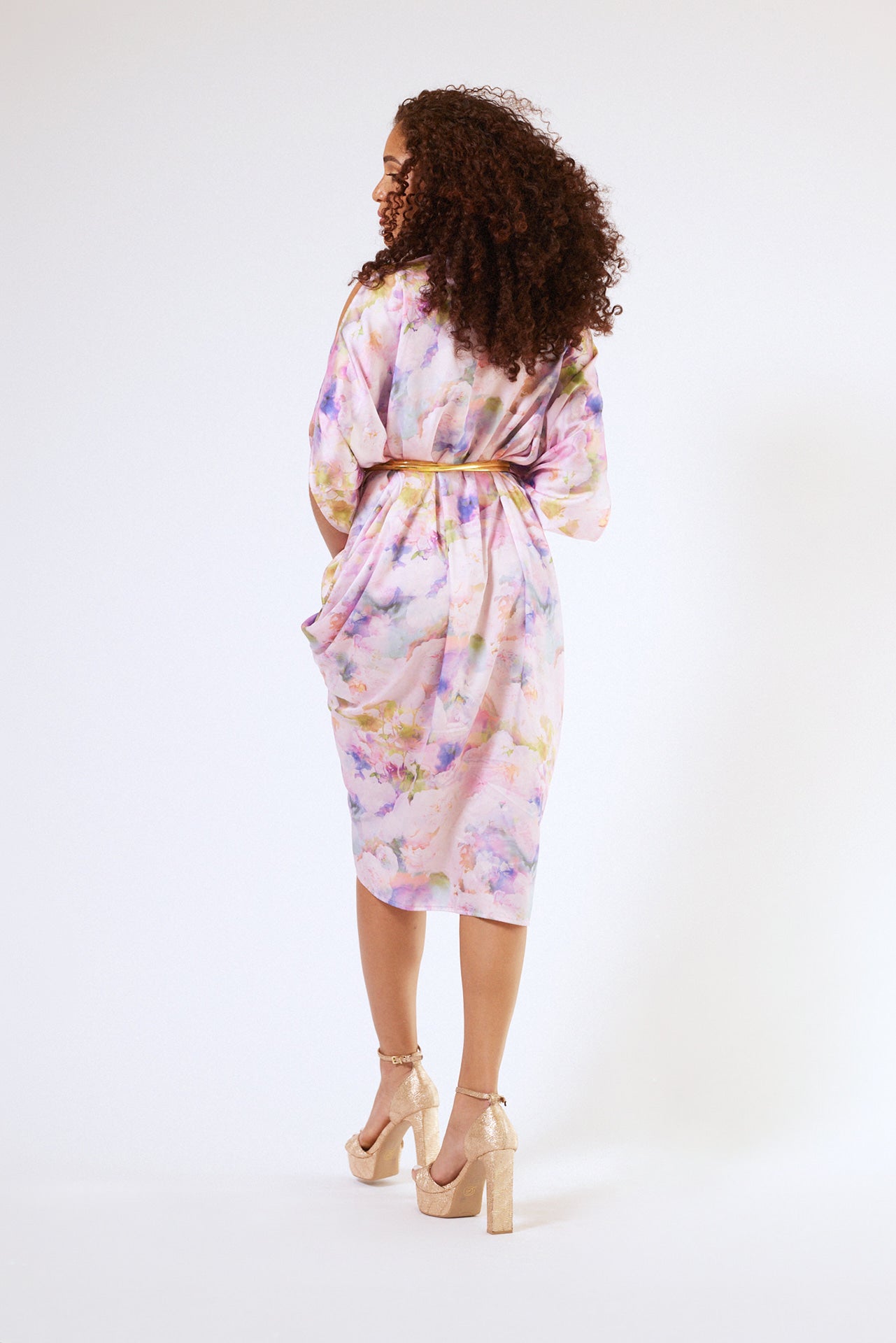 back profile of woman modelling pink floral kaftan duster with front zipper made from recycled textiles 5