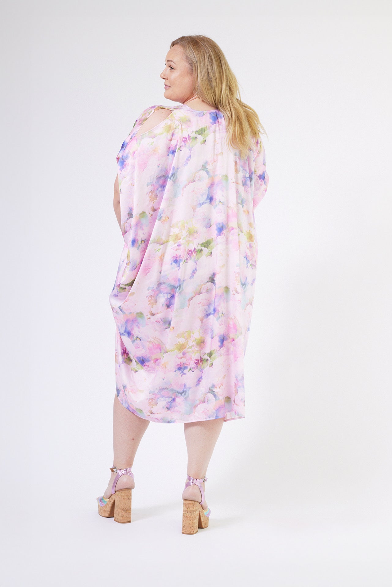 back profile of woman modelling pink floral kaftan duster with front zipper made from recycled textiles 6