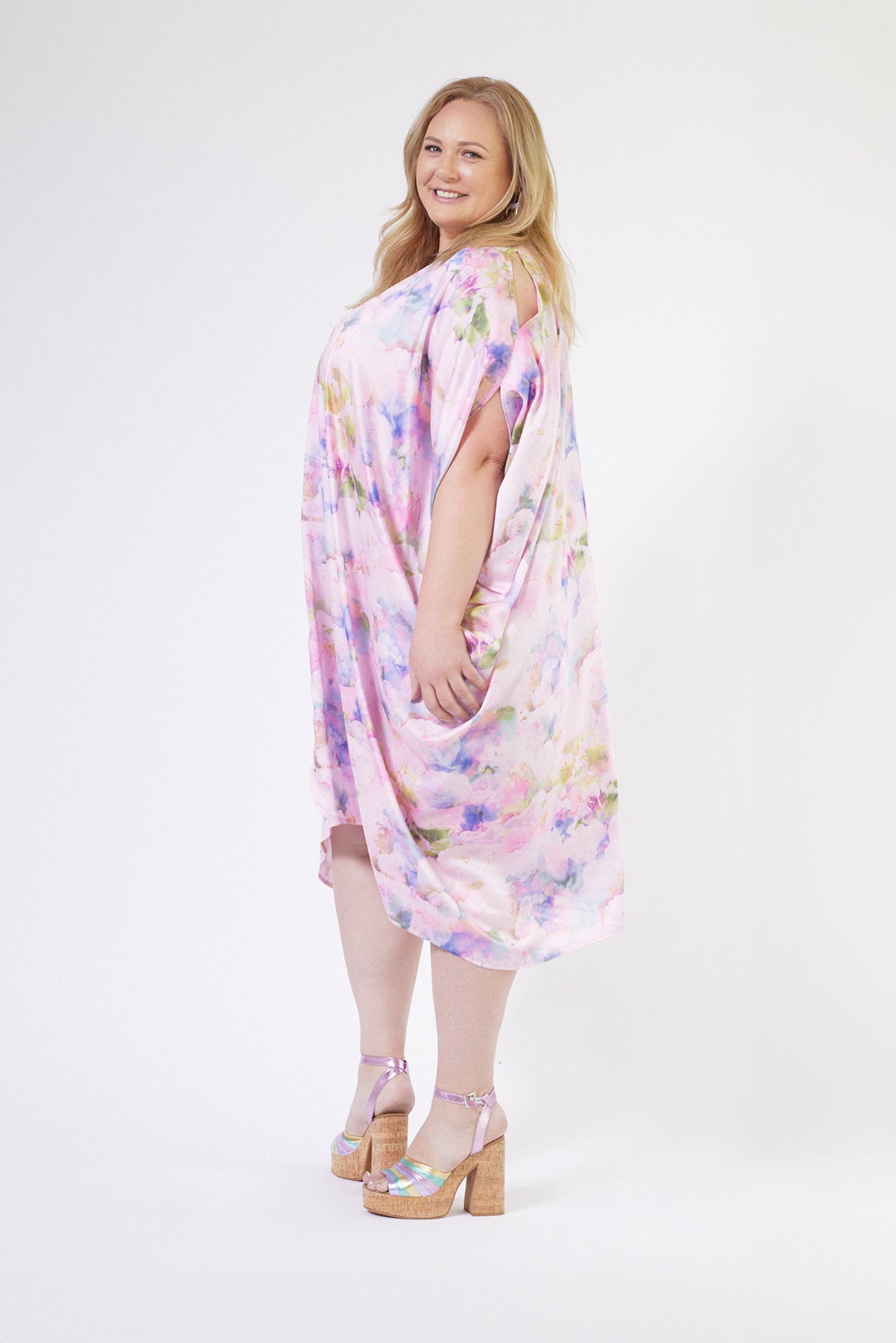 front profile of woman modelling pink floral kaftan duster with front zipper made from recycled textiles 5