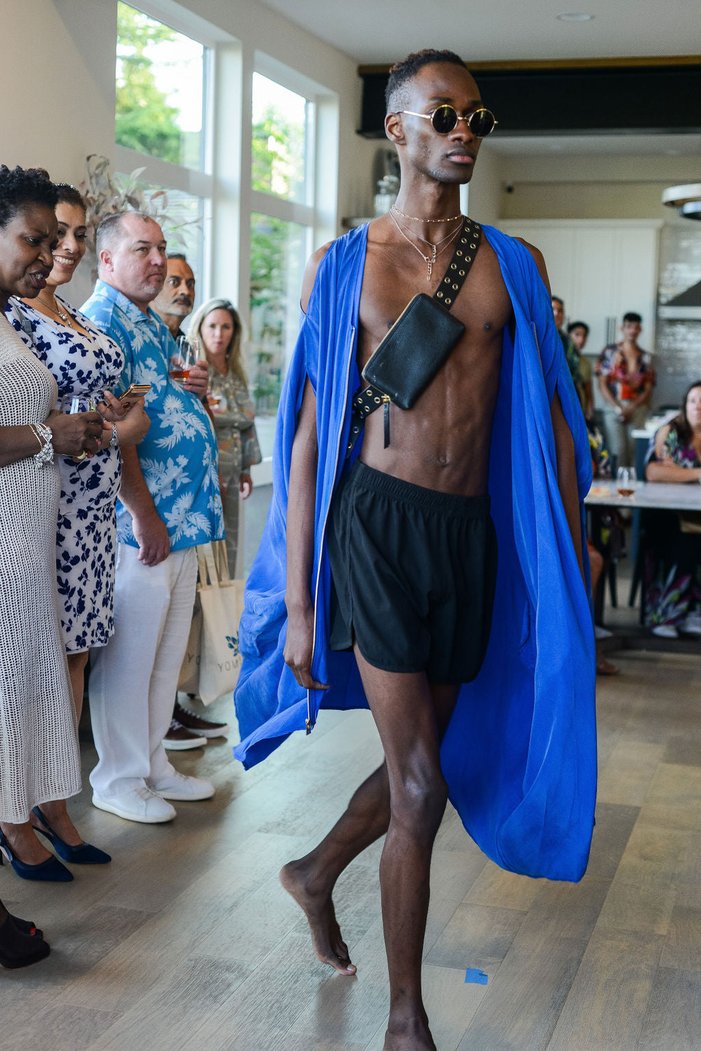 man modelling a royal blue kaftan duster with front zipper made from recycled materials 2