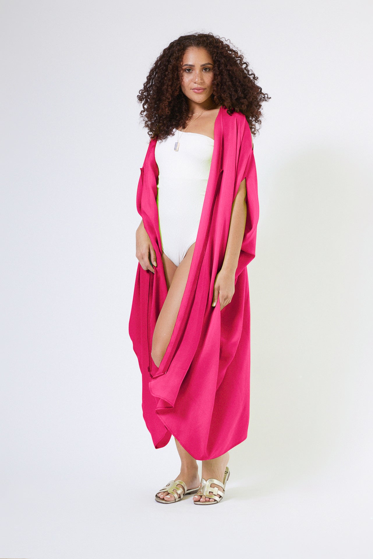 front profile view of woman wearing magenta kaftan duster with front zipper made from recycled materials 2