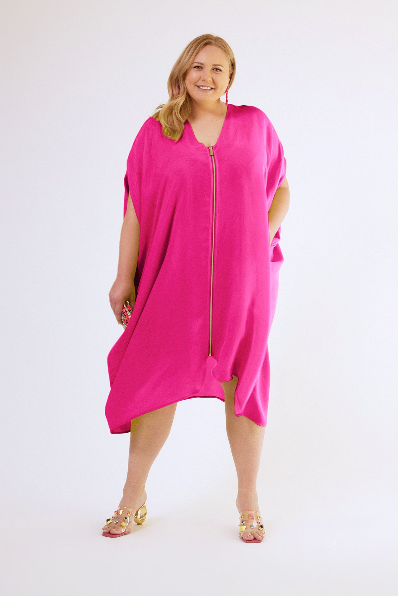 front profile view of woman wearing magenta kaftan duster with front zipper made from recycled materials 4
