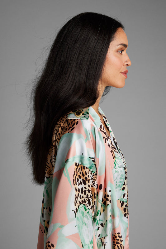 Side profile of woman wearing an all over animal print kimono duster made from recycled materials