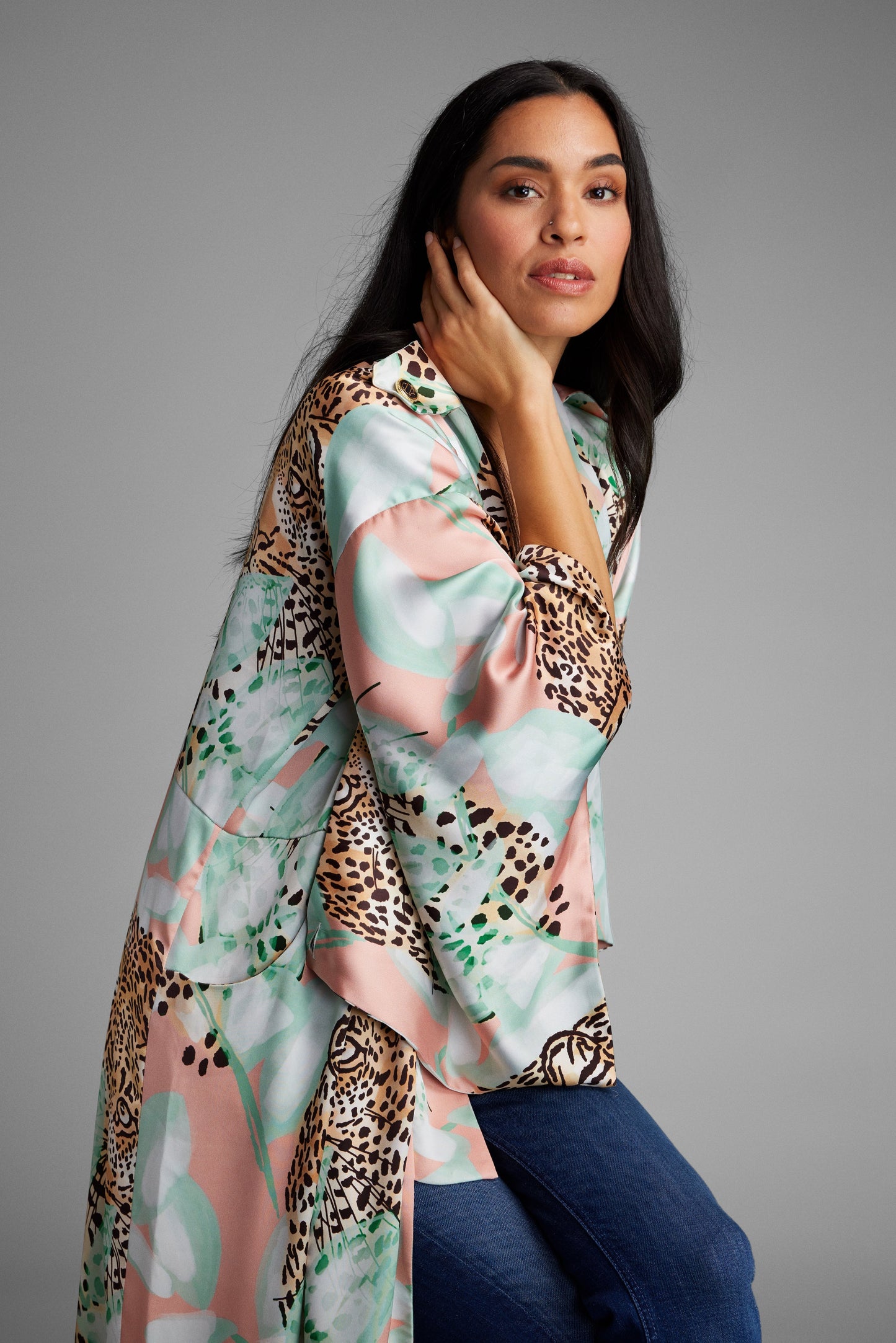 Woman wearing an all over tropical animal print kimono duster made from recycled materials
