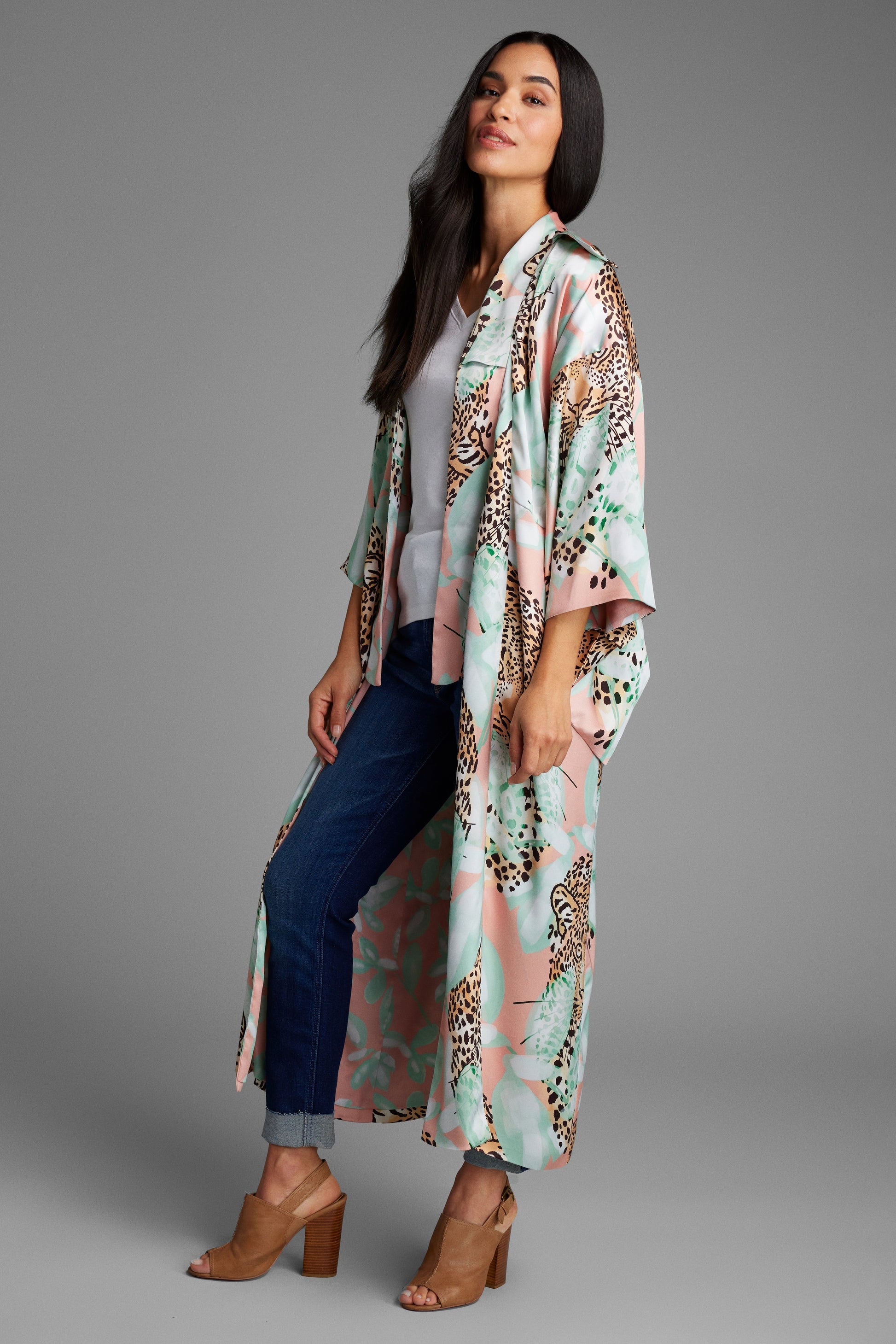 Woman wearing an all over tropical animal print kimono duster with pockets made from recycled materials