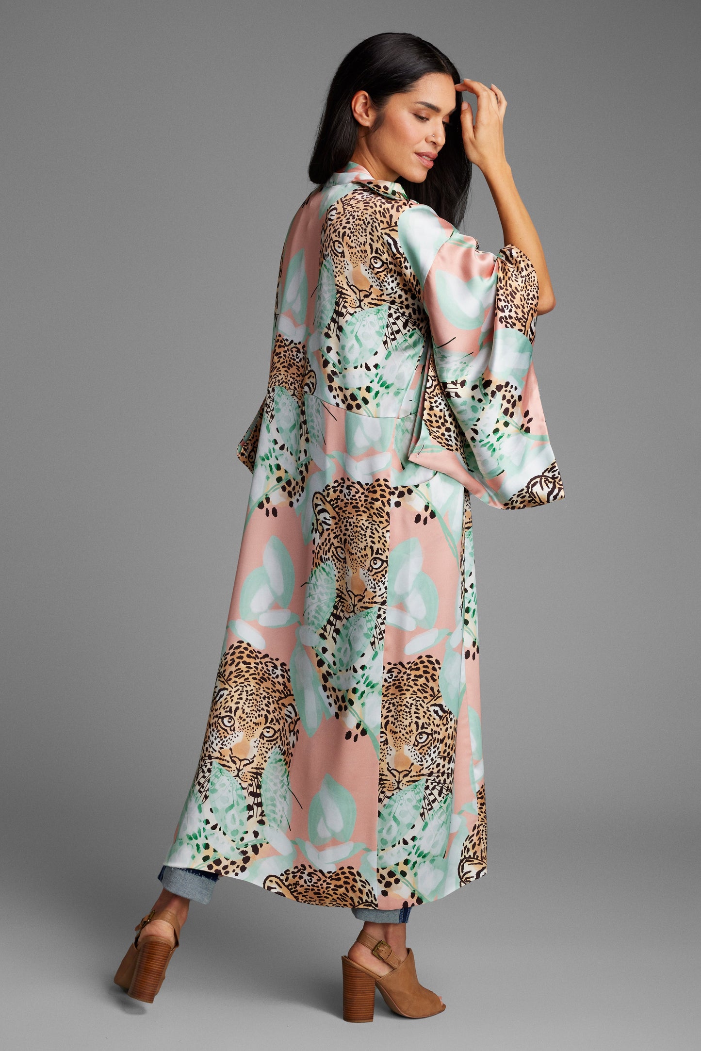 Woman showing her back wearing an all over tropical animal print kimono duster made from recycled materials