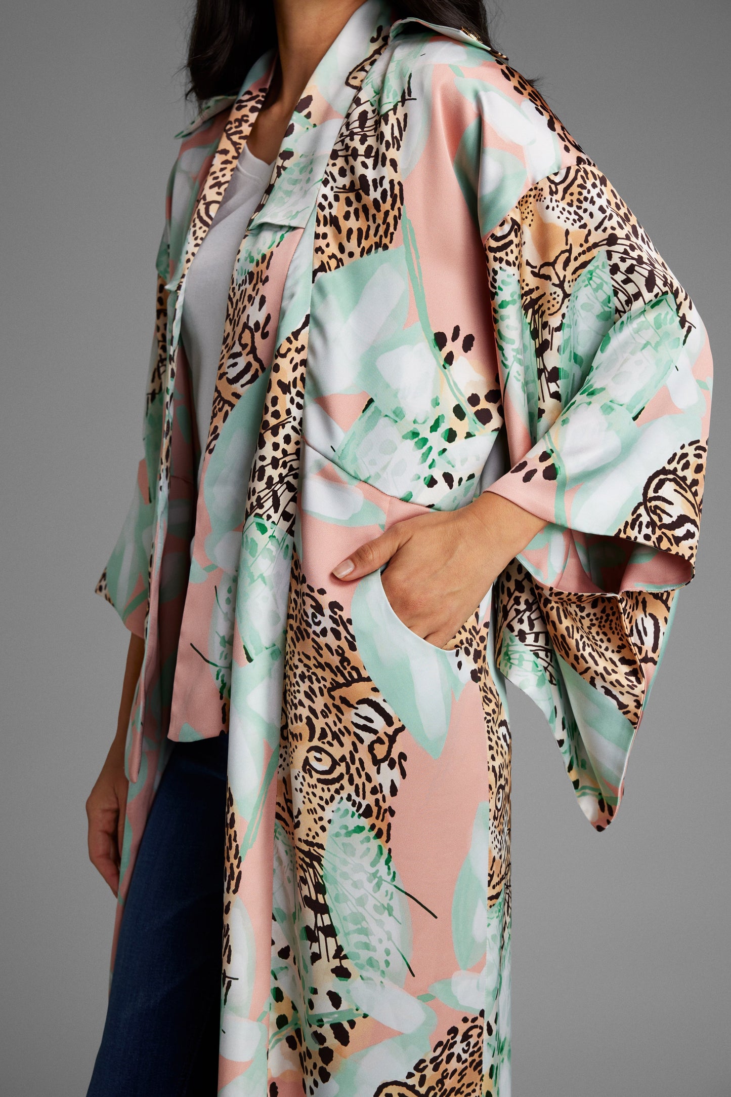 Woman wearing an all over tropical animal print kimono duster made from sustainable recycled materials