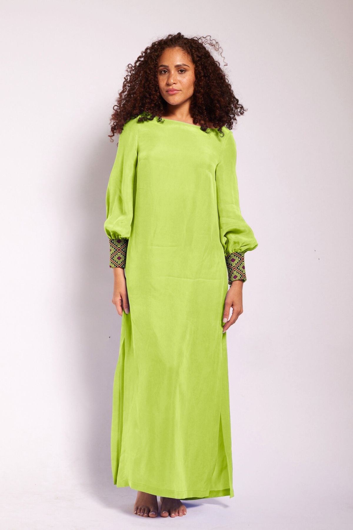 front view of woman modelling a bright yellow kaftan duster with embroidered sleeves made from recycled materials 6