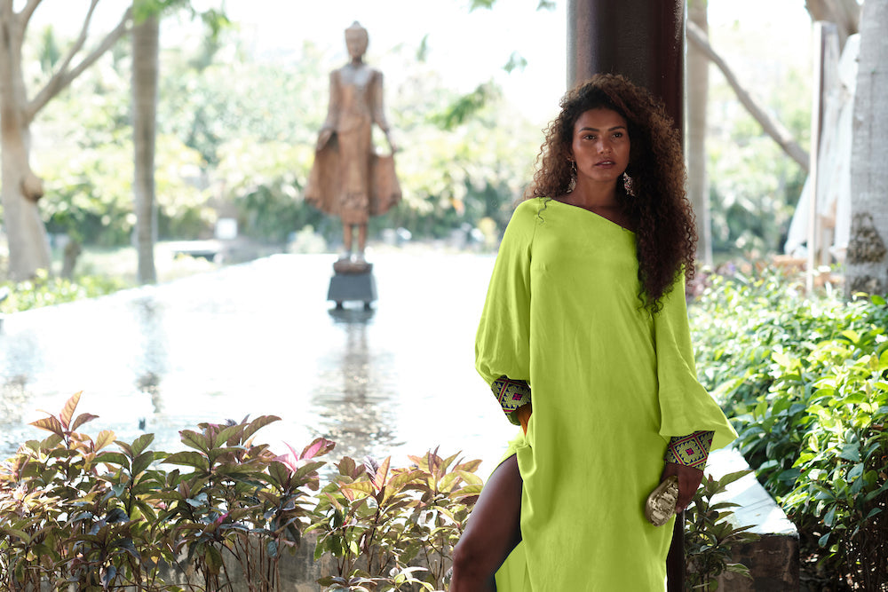 woman modelling a bright yellow kaftan duster with embroidered sleeves made from recycled materials 2