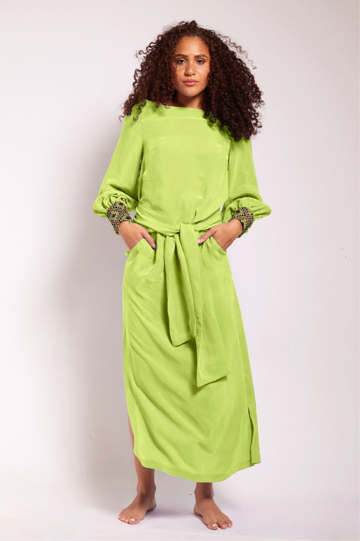 woman modelling a bright yellow kaftan duster with embroidered sleeves made from recycled materials 8